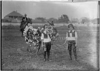 Agricultural fair, two boys in costume with decorated burro