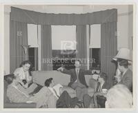 Photograph of Andre Weil (on couch); Serge Lang (on floor left); Peter Swinnerton-Dyer (floor right); E. Christopher "Chris" Zeeman (right holding lamp)