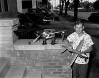 Boy with toy airplane; People