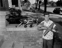 Boy with toy airplane; People