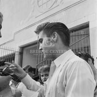 Photograph of Elvis Presley meeting fans