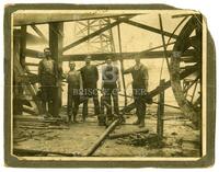 Casing crew, [five workmen underneath oil derrick]