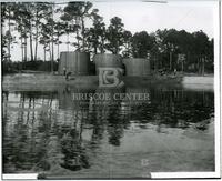 Wooden oil tanks body of water