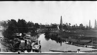 Panorama of construction and oil derricks in river basin