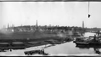 Panorama of construction and oil derricks in river basin