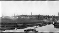 Panorama of construction and oil derricks in river basin