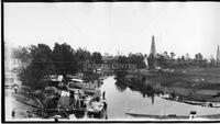 Panorama of construction and oil derricks in river basin