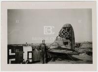 Photograph of man in front of World War II German military aircraft