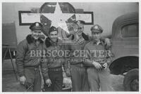 Photograph of U.S. military servicemen in front of military aircraft