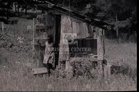 Girl outside of wooden building