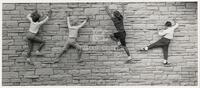 Children climbing a wall