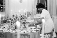 [White House maid setting the table for a state dinner]