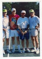 Bernard Rapoport, Dave Campbell, and two unidentified individuals playing tennis