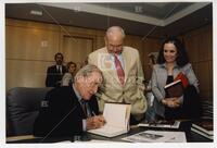 Bernard Rapoport with two unidentified individuals at "Being Rapoport" book signing