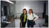 Audre Rapoport and unidentified woman standing in kitchen