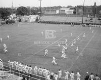 Annual staff, division pages, seniors silhouetted, football huddle