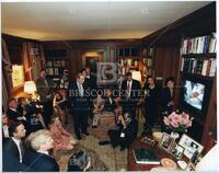 Bernard Rapoport watching television news with others, including Bill Clinton, Audre Rapoport, and Ben Barnes
