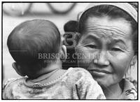 Laotian refugee woman holding a child