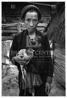 Hmong refugee man holding a chicken