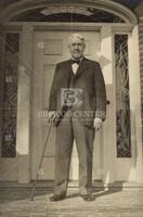 Frederick L. Fuller in front of his front door