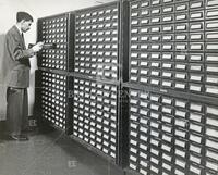 Unidentified man in front of file cabinet