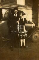 H.S. Wall with wife in front of a car