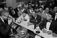 Malcolm X photographing Cassius Clay (Muhammad Ali)  at Hampton House victory celebration