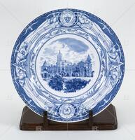 Photograph of a blue and white plate with the picture of the Old Main Building on it.