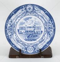 Photograph of a blue and white plate with a picture of the UT Home Economics Building. .