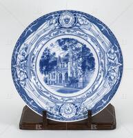 Photograph of a blue and white plate with a picture of the UT Law School. .