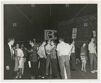 Photograph of students protesting, one holds a sign reading "Integrated Public Accommodations – UT Students"