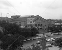Photograph of building (Gregory Gym?) with cars in front