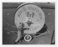 Photograph of Vincent R. DiNino and "Big Bertha" UT Longhorn Band drum, undated