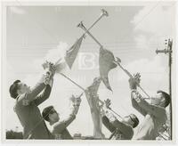 Photograph of four Longhorn Band members playing "Herald Trumpets"