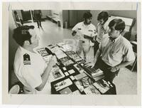 Photograph of Navy recruiters talking to UT students on campus