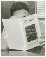 Photograph of UT student reading Riata, the student literary magazine