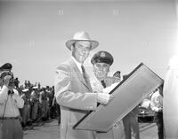 Jimmy Stewart with military man at a microphone