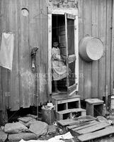 Young girl in doorway of home