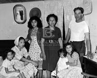 Father and mother with five of their eight children.