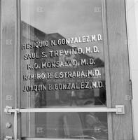 The names of the doctors on the front door of a clinic
