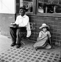 Beggar and a little boy on the street