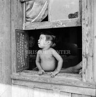 A baby who lives in a slum corral.