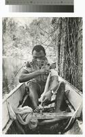 Photograph of a man in a boat in Suriname, 1964