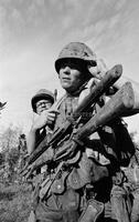 Photograph of a U.S. Marine with two rifles, 1967