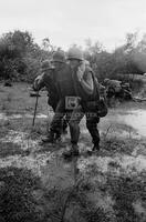 Photograph of U.S. Marines helping a wounded soldier, 1967