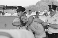 Photograph of a Vietnam War protester being arrested by the police, May 30, 1970
