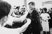 Photograph of John F. Kennedy and Jacqueline Kennedy shaking hands with supporters, 1963