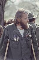Photograph of a Vietnam War veteran on crutches at a gathering to protest the Vietnam War, April 24, 1971