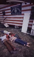 Photograph of Vietnam War protesters laying in front of a medical aid station, April 24, 1971