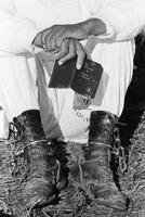 Photograph of a prisoner holding the New Testament, September 1995